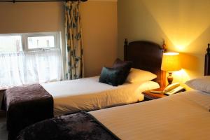 A bed or beds in a room at Bridge Hotel