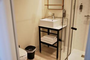 a small bathroom with a sink and a shower at H&ocirc;tel Life Marseille VP - Vieux Port in Marseille
