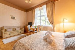 a bedroom with a bed and a table and a window at Apartments Vila Golf - Flucher Turizem in Rogaška Slatina