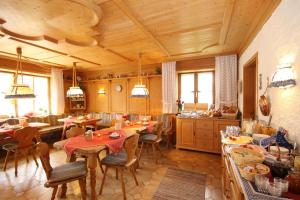 a kitchen with tables and chairs in a room at Pension Vendel in Pfronten