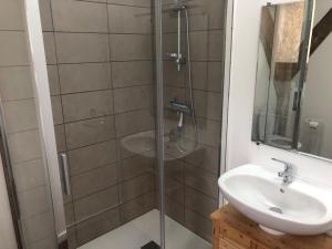 a bathroom with a shower and a sink at Le Séchoir in Beaulieu-sur-Dordogne +3 photos