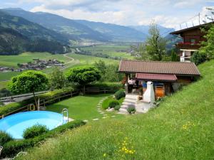 a house on a hill with a swimming pool at Holiday Home Egger - ZAZ379 by Interhome in Aschau