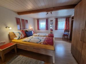 a bedroom with a large bed in a room at Holiday Home Egger by Interhome in Aschau +21 photos