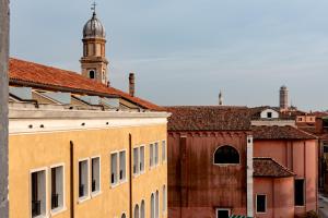 a building with a clock tower in a city at Il Palazzo Experimental in Venice