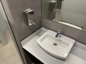 a bathroom with a white sink and a mirror at Welcome Aboard Yacht Cruiser! in Mataró