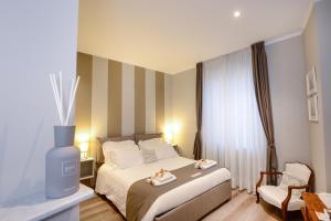 a hotel room with a bed and a chair at Il Genovino in Genoa