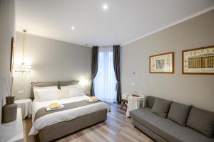 a hotel room with a bed and a couch at Il Genovino in Genoa