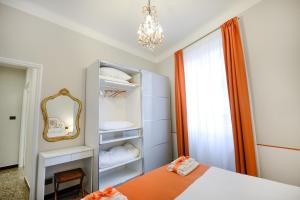 a bedroom with a bed and a mirror at Il Genovino in Genoa
