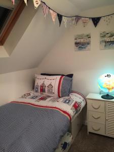 a childs bedroom with a bed and a desk at Craigewan Cottage Seatown Cullen in Cullen