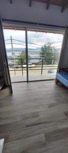 a room with a large sliding glass door with a view at Aparahik in Ushuaia +2 photos