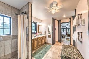 a bathroom with a shower and a ceiling fan at Hot Tub & Mtn Views! 'Casa Ruidoso' Cabin in Alto +37 photos