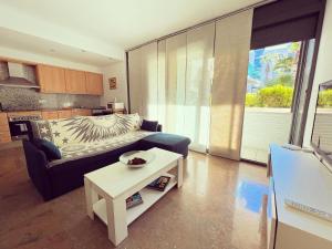 a living room with a couch and a table at Apartamento Con Piscina Lloret de Mar in Lloret de Mar
