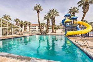 a pool with a water slide in a resort at Luxe Family Condo with Mtn View and Resort Perks! in St. George