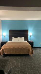 a bedroom with a large bed with a blue wall at Quality Inn & Suites in Edgefield +14 photos