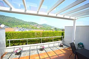 a balcony with a view of the mountains at Go Donosti Villa Berio in San Sebastián