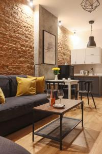 a living room with a couch and a table at Soft Loft 1 Apartment in Toruń