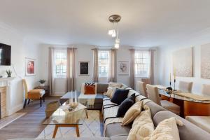 a living room with a couch and a table at Park Lane Apartments - Clarges Street in London