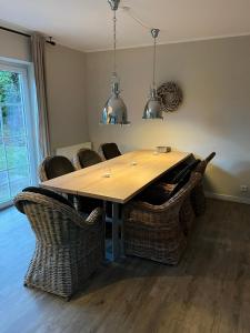 a dining room table with wicker chairs around it at Neptun17 in Scharbeutz