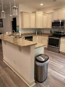 a kitchen with a counter and a trash can at Hidden Beach Oasis in Myrtle Beach