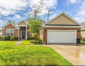 a brick house with a garage at Hidden Beach Oasis in Myrtle Beach