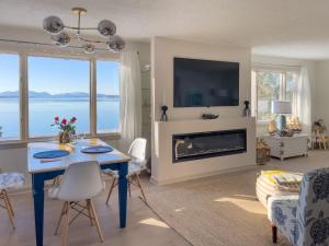 a living room with a table and a fireplace at Lucky Stone Retreat - private beach & Acadia view in Sullivan