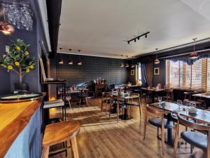 a restaurant with tables and chairs and a bar at Lezzet PG B&B &TurkishRestaurant in Warsaw