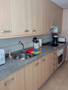 a kitchen with a sink and a counter top at CORMORANT SUITE, sea terrace & pools in La Manga del Mar Menor