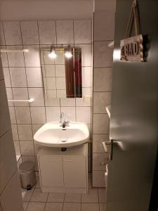 uma pequena casa de banho com um lavatório e um espelho em Ferienwohnung Isabell em Hahnenklee-Bockswiese