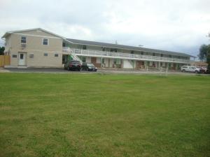 a large building with cars parked in front of it at Relax Inn in Streator