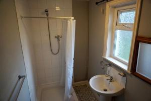 a bathroom with a shower and a sink at Adnans Hotel in Birmingham