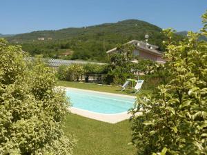 a swimming pool in a yard with a house at Casa dei Fiori in Casanova Lerrore