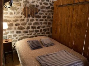 a bedroom with a bed with two pillows on it at La Bonbonnière in Le Chambon-sur-Lignon