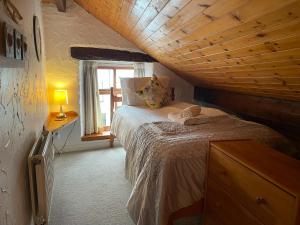 a bedroom with a bed and a wooden ceiling at Bakestones - Central Location with Free Integral Private Parking in Ambleside