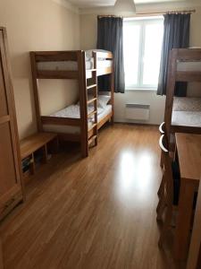 a room with two bunk beds and a window at Apartmán Abertamy in Abertamy