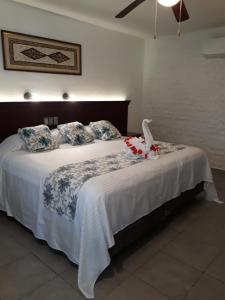 Voodi või voodid majutusasutuse Hotel Puerta Chichen toas