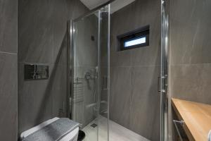 a bathroom with a shower with a glass shower stall at MIRMA CITY Old Town in Chania +60 photos