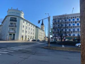 an empty city street with a traffic light and buildings at Zrinyi Central Apartman with free parking in Nyíregyháza
