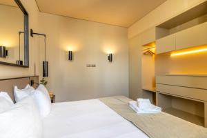 a bedroom with a large white bed with white pillows at Prime Lisbon - Dom Luis I in Lisbon