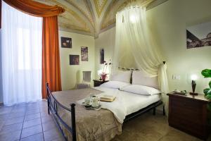 a bedroom with a bed with an ornate ceiling at Camere Del Re in Tarquinia