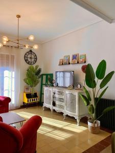 uma sala de estar com televisão e uma planta em Alojamiento estilo Boho con mucho encanto em Ponferrada