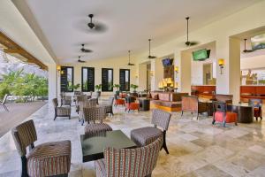 a lobby with tables and chairs and a bar at Occidental Nuevo Vallarta in Nuevo Vallarta
