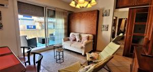 a living room with a couch and chairs and a table at Le Meyerbeer Promenade in Nice