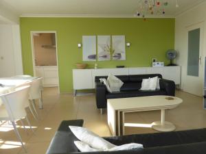 a living room with a couch and a table at Rapallo in Middelkerke