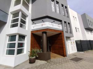 a large white building with a brown door at Rizi Corralejo Sun in Corralejo