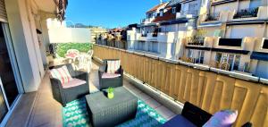 a balcony with chairs and a table on a building at Le Meyerbeer Promenade in Nice