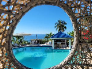 a pool at the resort with a view of the ocean at casaenjoysamana in Los Naranjos