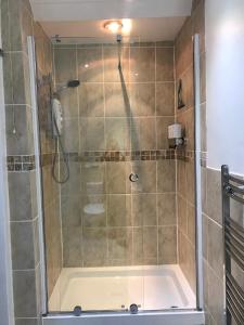 a shower with a glass door in a bathroom at Wisteria house in Plymouth +22 photos