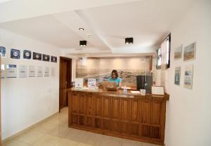 a woman standing at a counter in a restaurant at Playamar Bungalows in Playa del Ingles