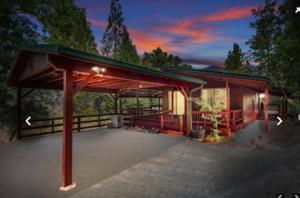 a cabin with a roof with a lights on it at Apple Belle Cabin Mountain Escape in Oakhurst
