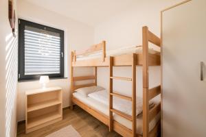 Voodi või voodid majutusasutuse Apartmaji BANONIA " Jutranja zarja " toas